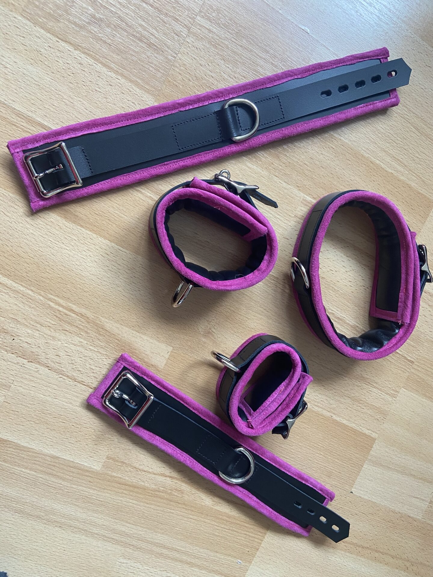 Pink BDSM bondage cuffs and collar set