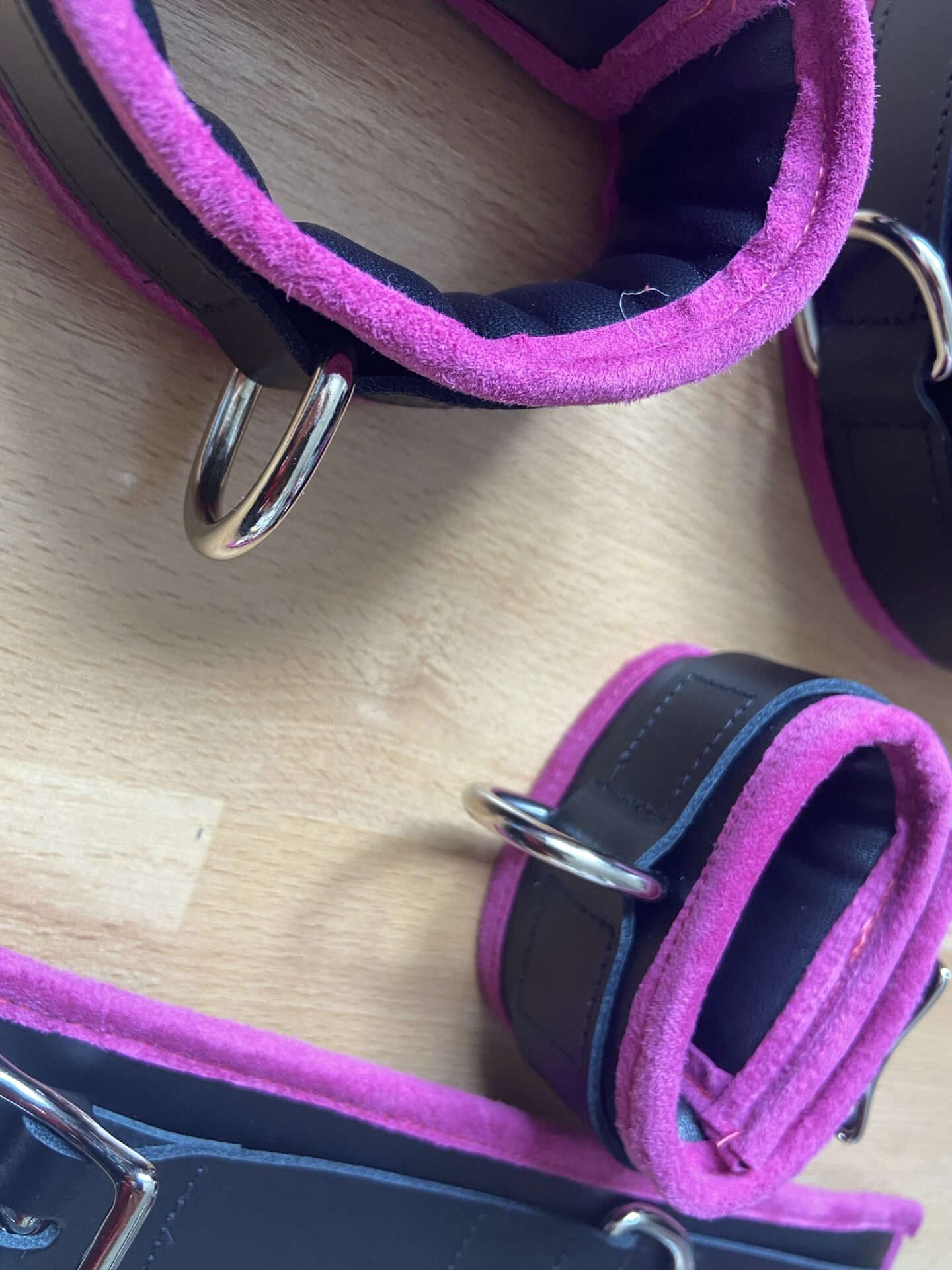 Pink BDSM bondage cuffs and collar set