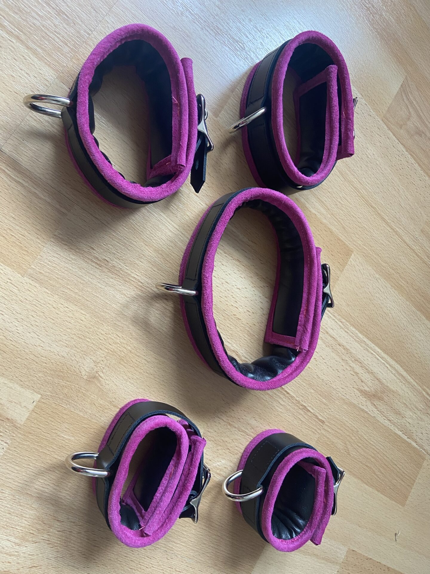 Pink BDSM bondage cuffs and collar set