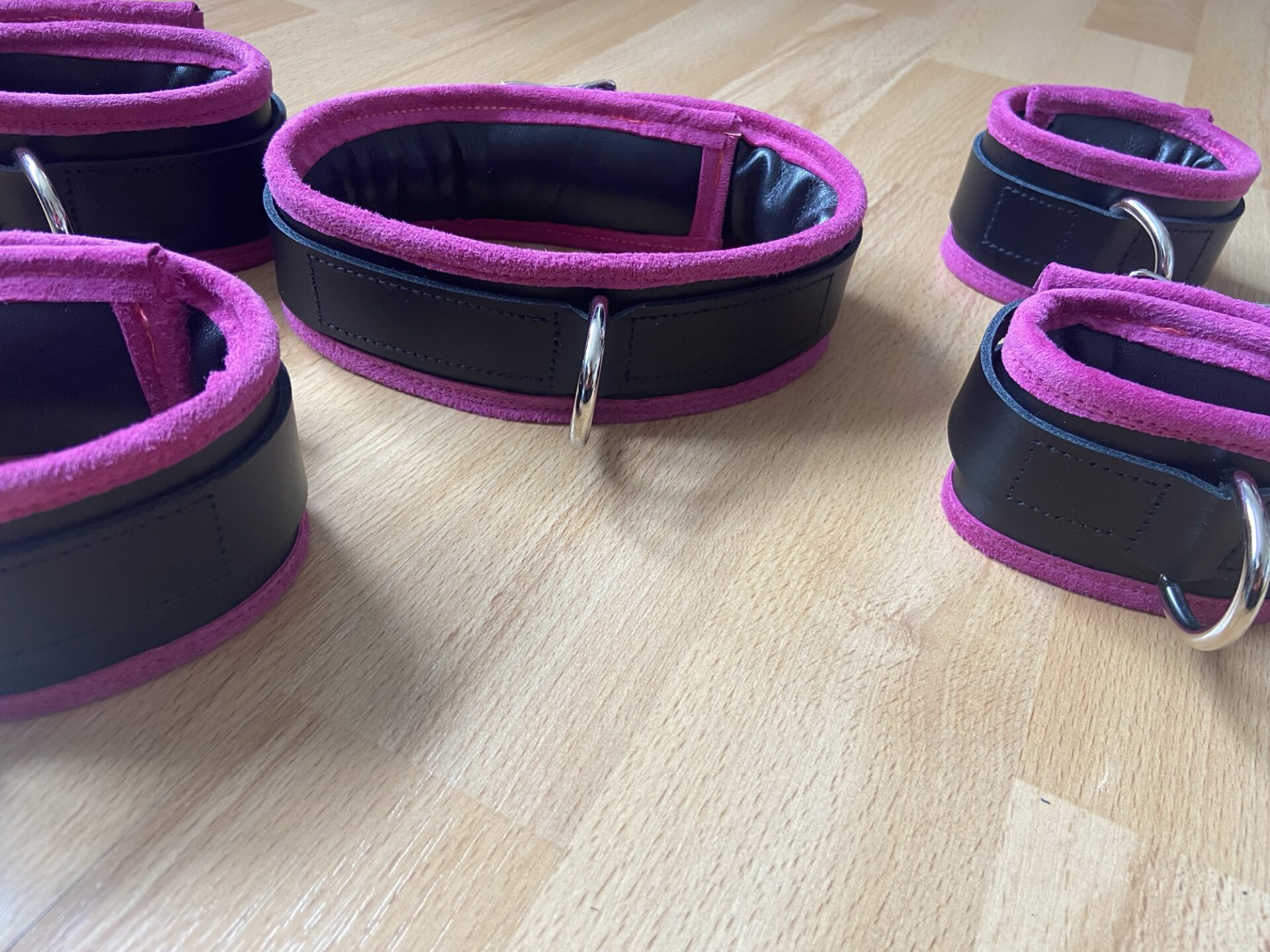 Pink BDSM bondage cuffs and collar set