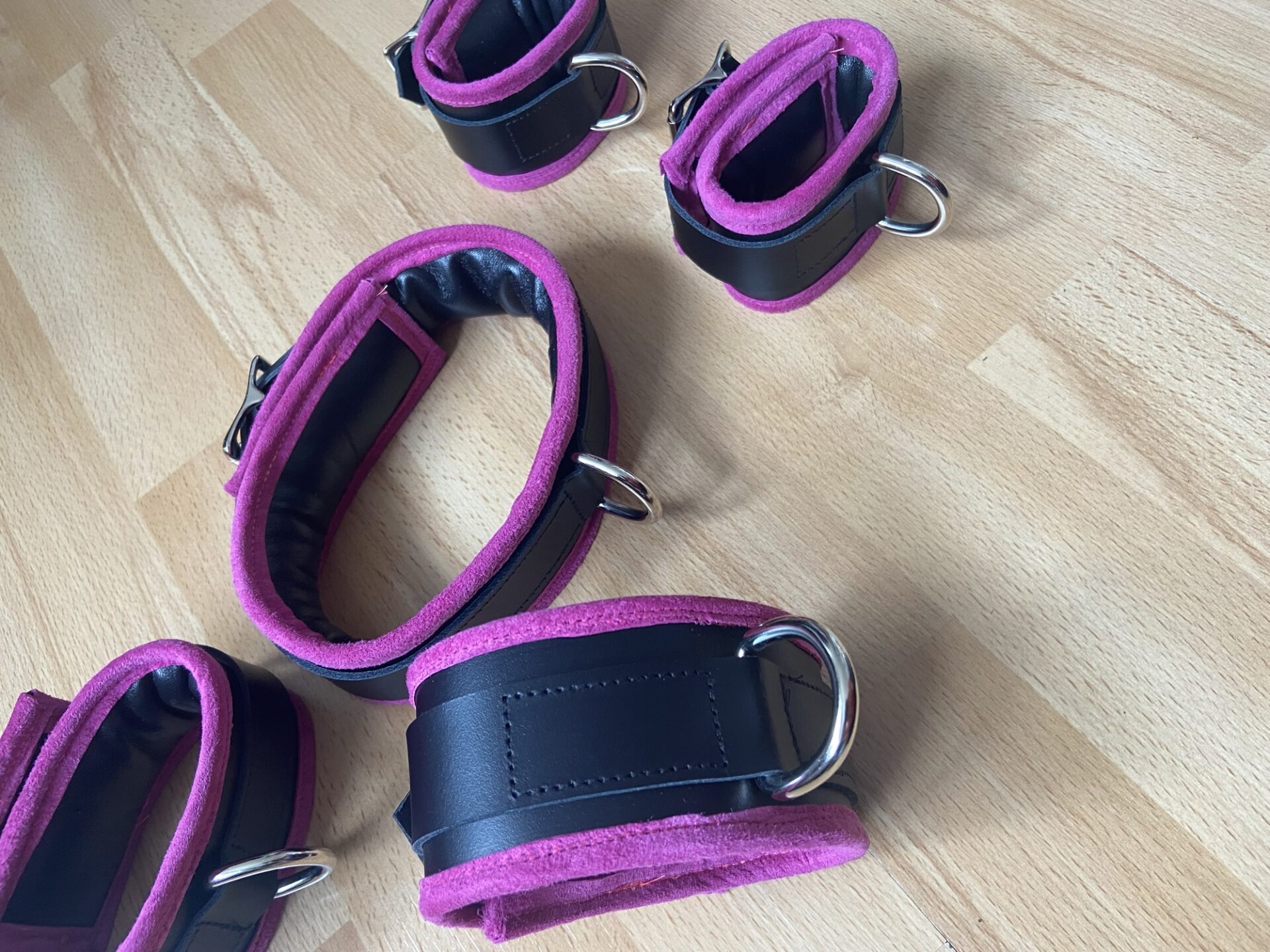 Pink BDSM bondage cuffs and collar set